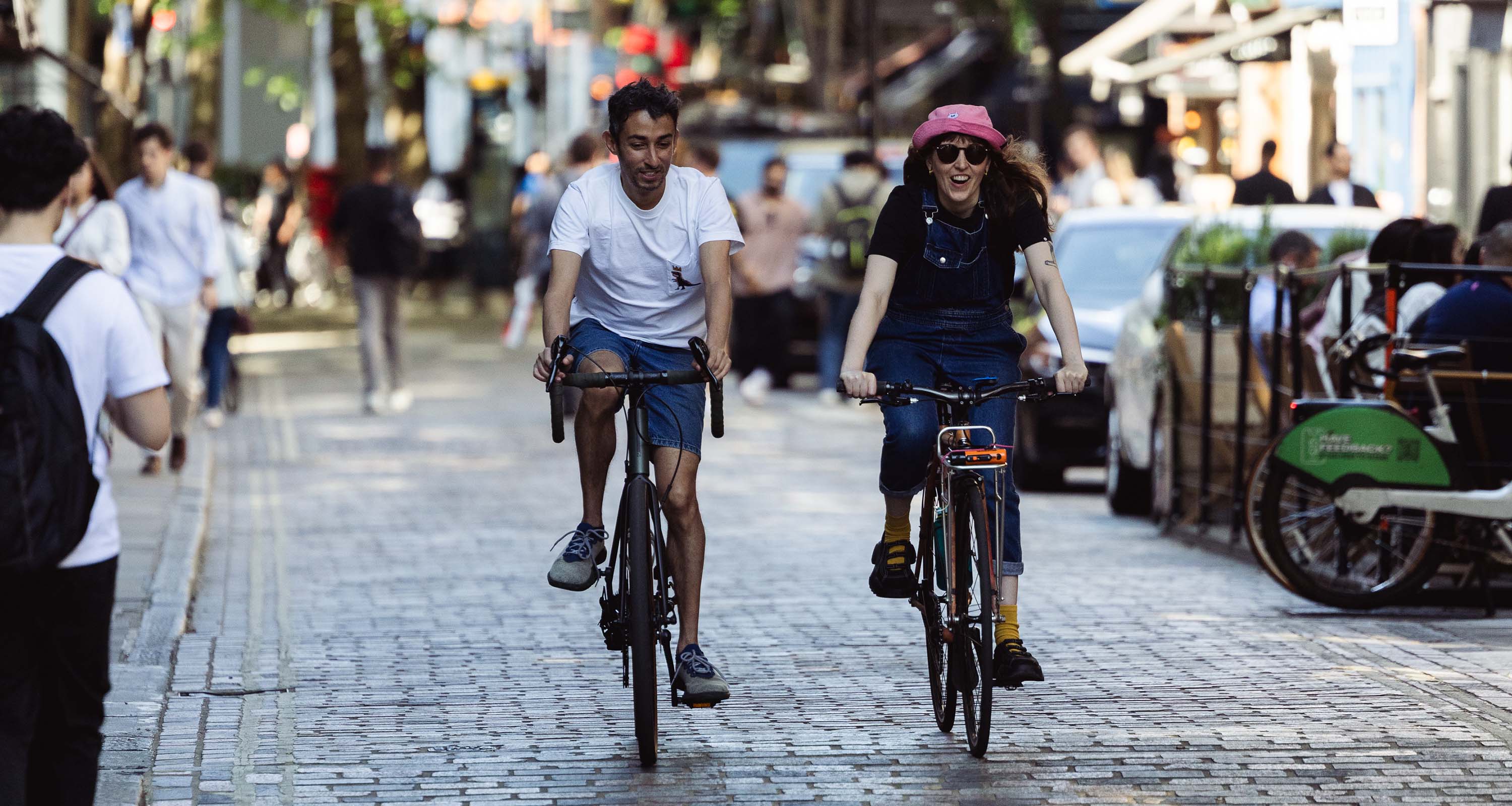 Man and woman cycling down a quiet street closed to motor vehicles